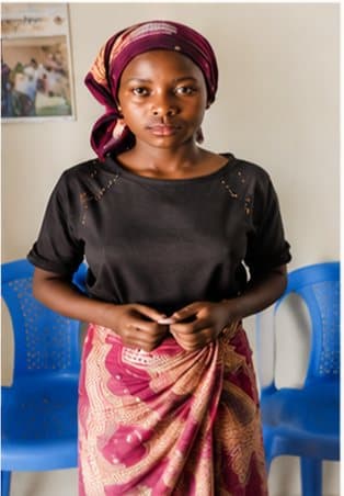 A young woman standing in a community meeting space
