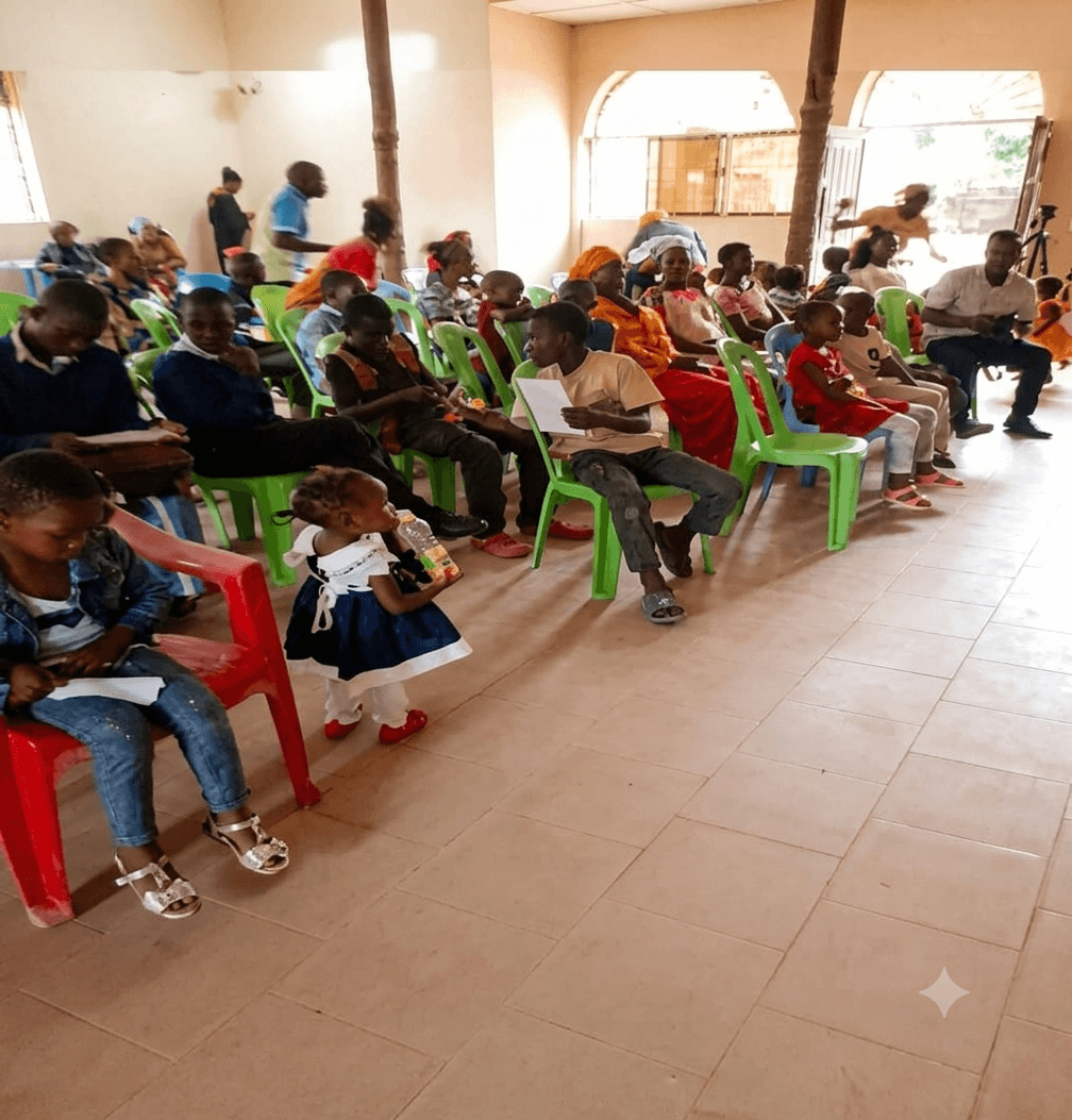 Mothers and young children seated together during a UPSDE youth and community development gathering